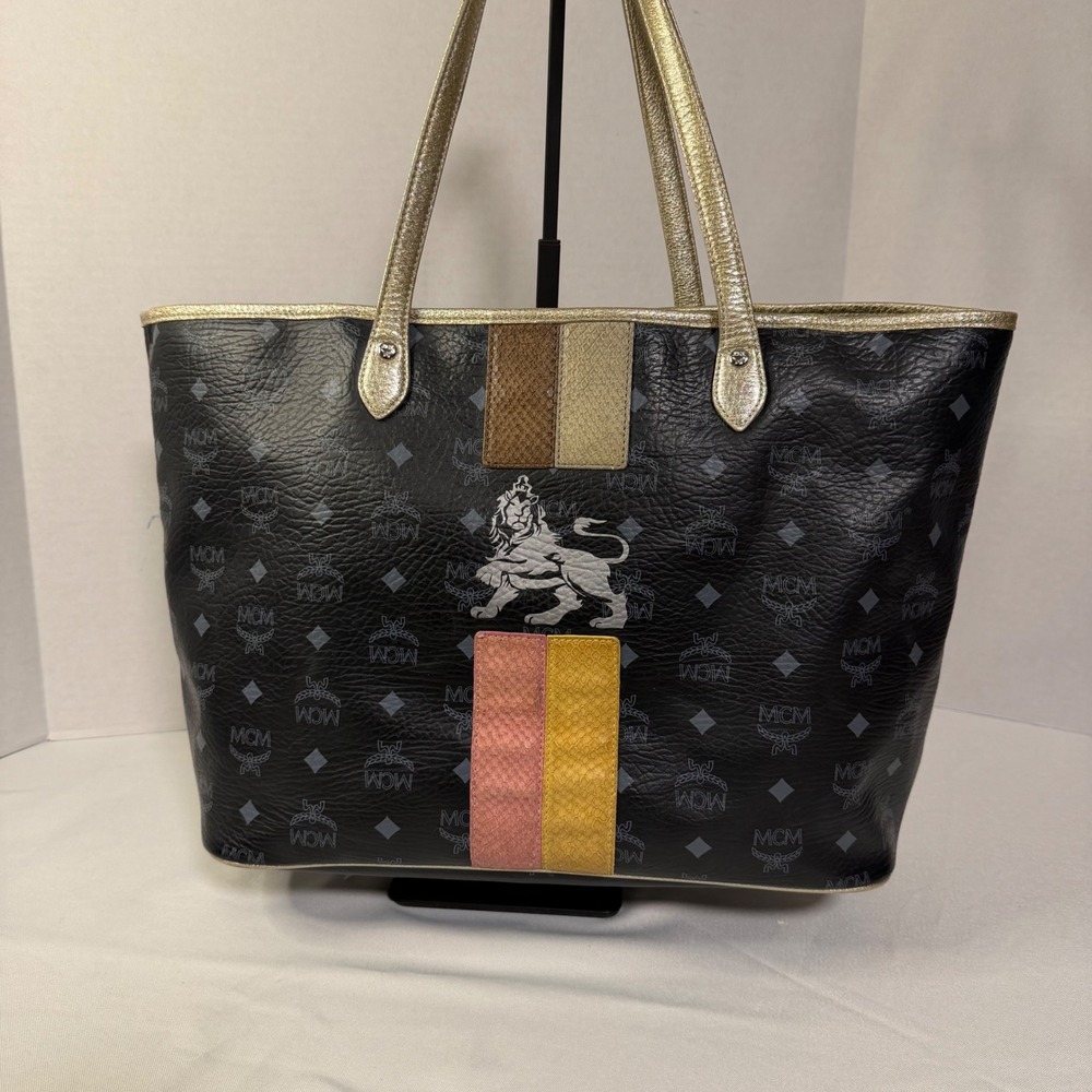 MCM Visetos Monogram Medium Tote Bag Black Gold‎ Lion Graphic Striped